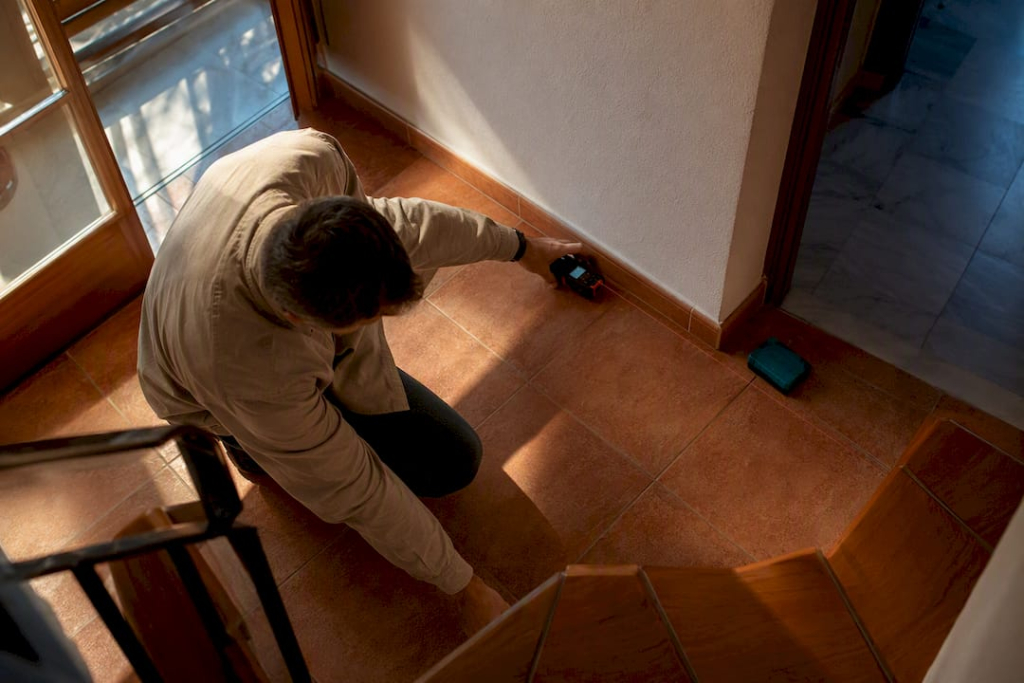 Valuer measuring Spanish townhouse interior